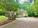 Charming home exterior featuring a well-manicured yard, a garage, and a driveway at 6673 Nc 96 W Hwy, Youngsville, NC 27596