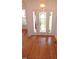 View of the foyer featuring hardwood floors with inlaid starburst design and leaded glass front door at 6673 Nc 96 W Hwy, Youngsville, NC 27596