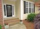 Close up of the front entrance, showcasing the brick steps and decorative leaded glass front door at 6673 Nc 96 W Hwy, Youngsville, NC 27596