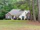 Attractive home featuring a well-maintained lawn, complemented by brick and siding and dark shutters at 6673 Nc 96 W Hwy, Youngsville, NC 27596