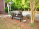 Landscaped front yard featuring a wooden bench, birdhouse, and vibrant rose bushes at 6673 Nc 96 W Hwy, Youngsville, NC 27596