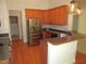 Kitchen showcasing stainless steel appliances, wooden cabinets, and a countertop bar at 6673 Nc 96 W Hwy, Youngsville, NC 27596