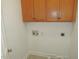 Small laundry room with utility connections and overhead cabinet at 6673 Nc 96 W Hwy, Youngsville, NC 27596