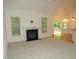 Living room featuring a fireplace and access to an outdoor deck at 6673 Nc 96 W Hwy, Youngsville, NC 27596
