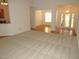 Open-concept living room with carpet flooring with open view of dining room and foyer at 6673 Nc 96 W Hwy, Youngsville, NC 27596