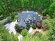 Stunning aerial view of a home surrounded by lush greenery and a private pool oasis at 754 Olde Thompson Creek Ct Rd, Apex, NC 27523