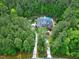 Aerial view of a home with a private driveway surrounded by beautiful mature trees and landscaping at 754 Olde Thompson Creek Ct Rd, Apex, NC 27523
