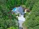 Aerial view of home showcasing backyard pool oasis, surrounded by lush landscaping and tall trees at 754 Olde Thompson Creek Ct Rd, Apex, NC 27523