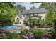 Lush backyard with swimming pool, patio, screened porch, and beautiful landscaping at 754 Olde Thompson Creek Ct Rd, Apex, NC 27523