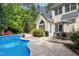 Inviting backyard with a pool, lush trees, dining area, and patio, great for outdoor enjoyment and relaxation at 754 Olde Thompson Creek Ct Rd, Apex, NC 27523