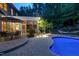 Outdoor patio area includes a table, umbrella, screened-in porch, hammock, and illuminated in-ground swimming pool at 754 Olde Thompson Creek Ct Rd, Apex, NC 27523