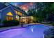 Beautiful backyard with pool, screened porch, dining area, and professional landscaping at sunset at 754 Olde Thompson Creek Ct Rd, Apex, NC 27523