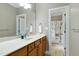 Bright bathroom features a white countertop vanity with a view into the toilet and shower stall at 754 Olde Thompson Creek Ct Rd, Apex, NC 27523