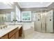 Bathroom with a large mirror, soaking tub, and glass-enclosed shower at 754 Olde Thompson Creek Ct Rd, Apex, NC 27523