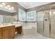 Bright bathroom with a large mirror, soaking tub, and glass-enclosed shower at 754 Olde Thompson Creek Ct Rd, Apex, NC 27523