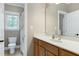 A bathroom with a wooden vanity, and a view into a separate room with a toilet and shower at 754 Olde Thompson Creek Ct Rd, Apex, NC 27523