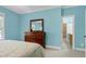 Comfortable bedroom featuring a wooden dresser, a bed with a floral patterned bedspread, and a neutral carpet at 754 Olde Thompson Creek Ct Rd, Apex, NC 27523
