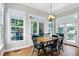 Charming dining area filled with light from large windows, hardwood floor, and access to the backyard at 754 Olde Thompson Creek Ct Rd, Apex, NC 27523