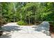 Circular driveway with ample space surrounded by beautiful trees, offering convenience and natural beauty at 754 Olde Thompson Creek Ct Rd, Apex, NC 27523