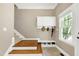 Welcoming entryway with stairs, storage cabinets, and a window with natural light at 754 Olde Thompson Creek Ct Rd, Apex, NC 27523