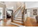 Elegant entryway featuring hardwood floors, staircase, and open view to living areas at 754 Olde Thompson Creek Ct Rd, Apex, NC 27523