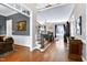 Elegant foyer showcasing hardwood floors, a staircase, and seamless transition to a comfortable living room at 754 Olde Thompson Creek Ct Rd, Apex, NC 27523