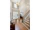 Spacious foyer with high ceilings, hardwood floors, staircase and decorative touches creating an elegant entrance at 754 Olde Thompson Creek Ct Rd, Apex, NC 27523