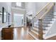 Grand foyer with soaring ceilings, hardwood floors, staircase and an inviting view of the interior at 754 Olde Thompson Creek Ct Rd, Apex, NC 27523