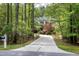 Attractive home nestled among mature trees and professional landscaping, offering privacy at 754 Olde Thompson Creek Ct Rd, Apex, NC 27523