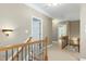 Hallway with wood railings and a view of a bedroom and a bonus room at 754 Olde Thompson Creek Ct Rd, Apex, NC 27523
