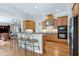 Open-concept kitchen with breakfast bar, wood cabinets, and stainless steel appliances at 754 Olde Thompson Creek Ct Rd, Apex, NC 27523