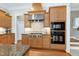 Stylish kitchen featuring custom wood cabinetry, granite countertops, and stainless steel appliances at 754 Olde Thompson Creek Ct Rd, Apex, NC 27523