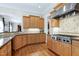 Traditional kitchen with stainless steel appliances, granite countertops, and natural wood cabinets at 754 Olde Thompson Creek Ct Rd, Apex, NC 27523