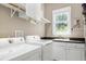 Functional laundry room featuring a washer, dryer, sink, and storage cabinets at 754 Olde Thompson Creek Ct Rd, Apex, NC 27523