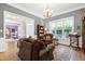 Inviting living room with hardwood floors, bookshelves, comfortable seating and view to the foyer at 754 Olde Thompson Creek Ct Rd, Apex, NC 27523