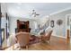 Spacious living room with fireplace, staircase, hardwood flooring, and plenty of natural light at 754 Olde Thompson Creek Ct Rd, Apex, NC 27523