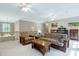 Bright living room area with comfortable seating, a ceiling fan, and railing overlooking the lower level at 754 Olde Thompson Creek Ct Rd, Apex, NC 27523