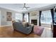 Comfortable living room with a fireplace, hardwood floors, and lots of natural light at 754 Olde Thompson Creek Ct Rd, Apex, NC 27523