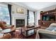 Cozy living room with a fireplace, hardwood flooring, and elegant furnishings at 754 Olde Thompson Creek Ct Rd, Apex, NC 27523