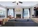Bright living room featuring a fireplace, large windows, hardwood flooring, and neutral décor at 754 Olde Thompson Creek Ct Rd, Apex, NC 27523