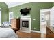 Bright main bedroom featuring a fireplace and a glimpse of the luxurious ensuite bathroom at 754 Olde Thompson Creek Ct Rd, Apex, NC 27523
