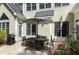 Back patio featuring an outdoor dining area, grill, and a view of the landscaped yard at 754 Olde Thompson Creek Ct Rd, Apex, NC 27523