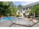 Relaxing backyard oasis features a swimming pool, hammock, and stone patio, creating the perfect retreat at 754 Olde Thompson Creek Ct Rd, Apex, NC 27523