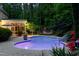 Glowing in-ground pool, patio dining set, hammock, screened-in porch and lush landscaping at 754 Olde Thompson Creek Ct Rd, Apex, NC 27523
