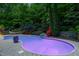 Illuminated in-ground pool, lush landscaping, patio with stone pavers, and a hammock at 754 Olde Thompson Creek Ct Rd, Apex, NC 27523