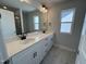 Bright bathroom featuring a double vanity with modern fixtures and a large mirror, complemented by neutral tones at 773 Portland Rose Dr, Knightdale, NC 27545