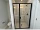 Sleek bathroom with glass enclosed shower featuring gray tiling and modern fixtures, offering a spa-like experience at 773 Portland Rose Dr, Knightdale, NC 27545