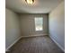 Small bedroom featuring neutral carpet, a single window, and light colored walls at 773 Portland Rose Dr, Knightdale, NC 27545