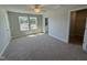 Spacious primary bedroom with neutral carpet, a ceiling fan, and an en-suite bathroom at 773 Portland Rose Dr, Knightdale, NC 27545