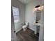 Well-lit half bathroom featuring a modern vanity and wood-look flooring at 773 Portland Rose Dr, Knightdale, NC 27545